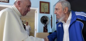 Pope Francis and Cuba's Fidel Castro shakes hands, in Havana, Cuba, Sunday, Sept. 20, 2015. The Vatican described the 40-minute meeting at Castro's residence as informal and familial, with an exchange of books. (AP Photo/Alex Castro)